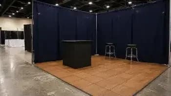 What Trade Show Flooring Costs: Shipping, Drayage, and the Cheap Way In