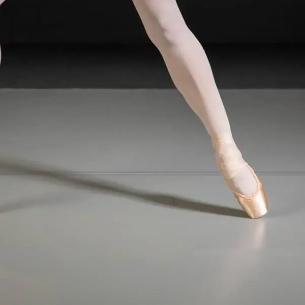 Ballet pointe shoes on a smooth gray ProStep Marley dance floor.