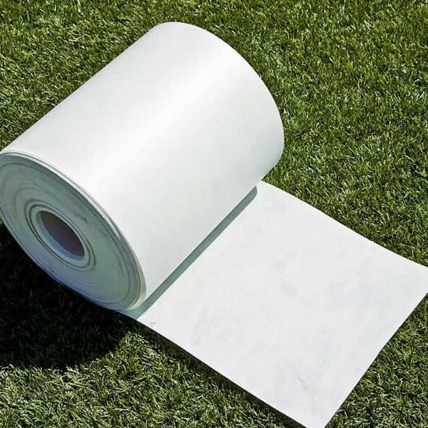Artificial turf seam tape roll on synthetic grass.